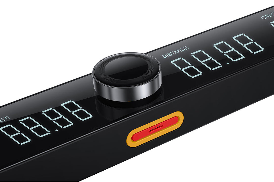 Console speed dial with a black casing plus a digital display, and red safety key on a white background