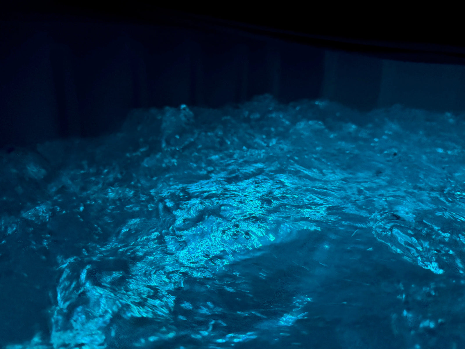 Bubbling hot water in the EZLIFE black 6-person inflatable hot tub for destressing low cost and affordable