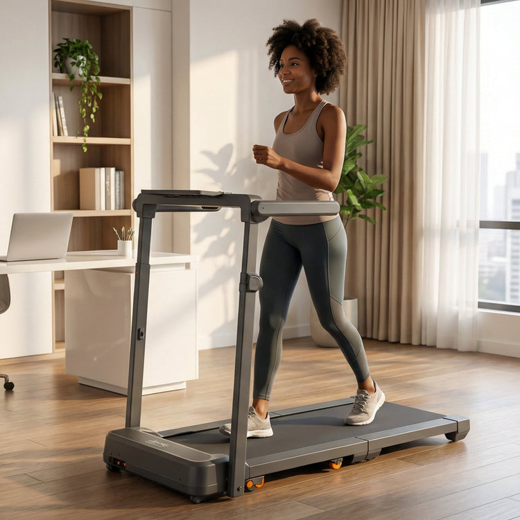 Woman using a walking pad treadmill in a home office setting with large windows and bookshelves.
