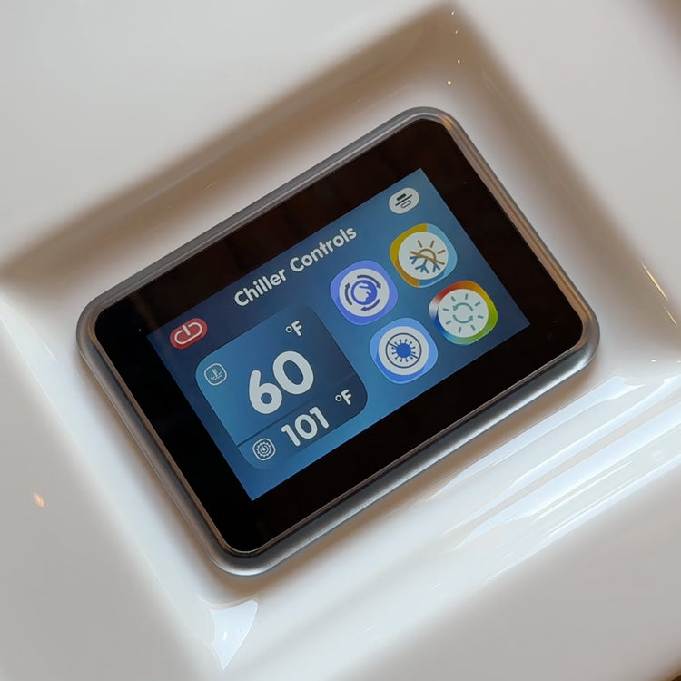 Digital display showing chiller controls with temperature readings on a white surface