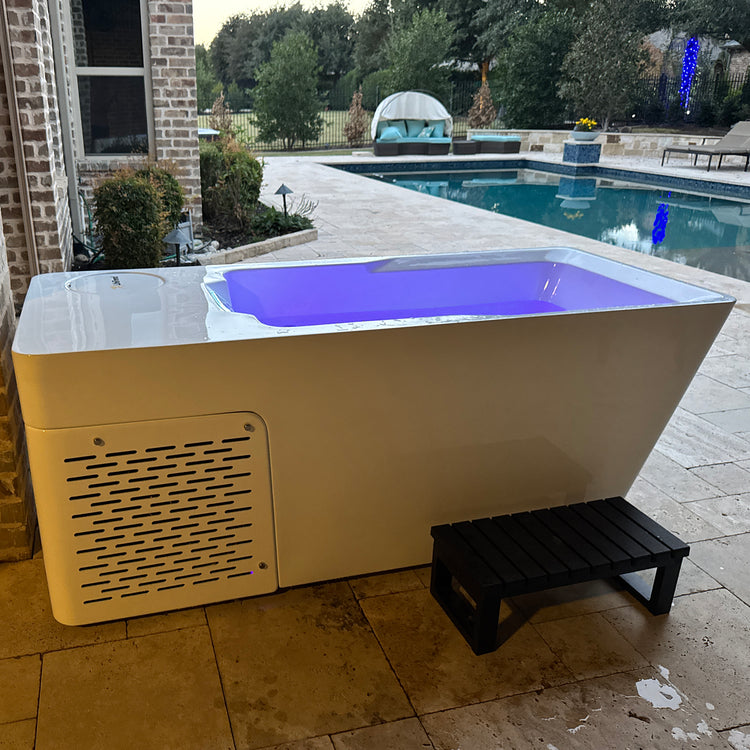 Solidtube cold and hot tub outside by a pool with steps
