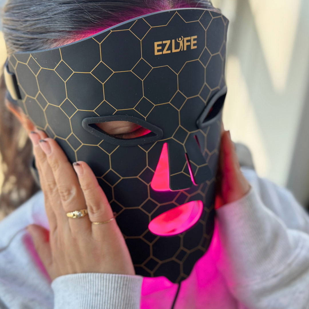 Person wearing a black LED face mask with hexagonal pattern and 'EZLIFE' branding. Red Light Mask with Infrared Light and vibration