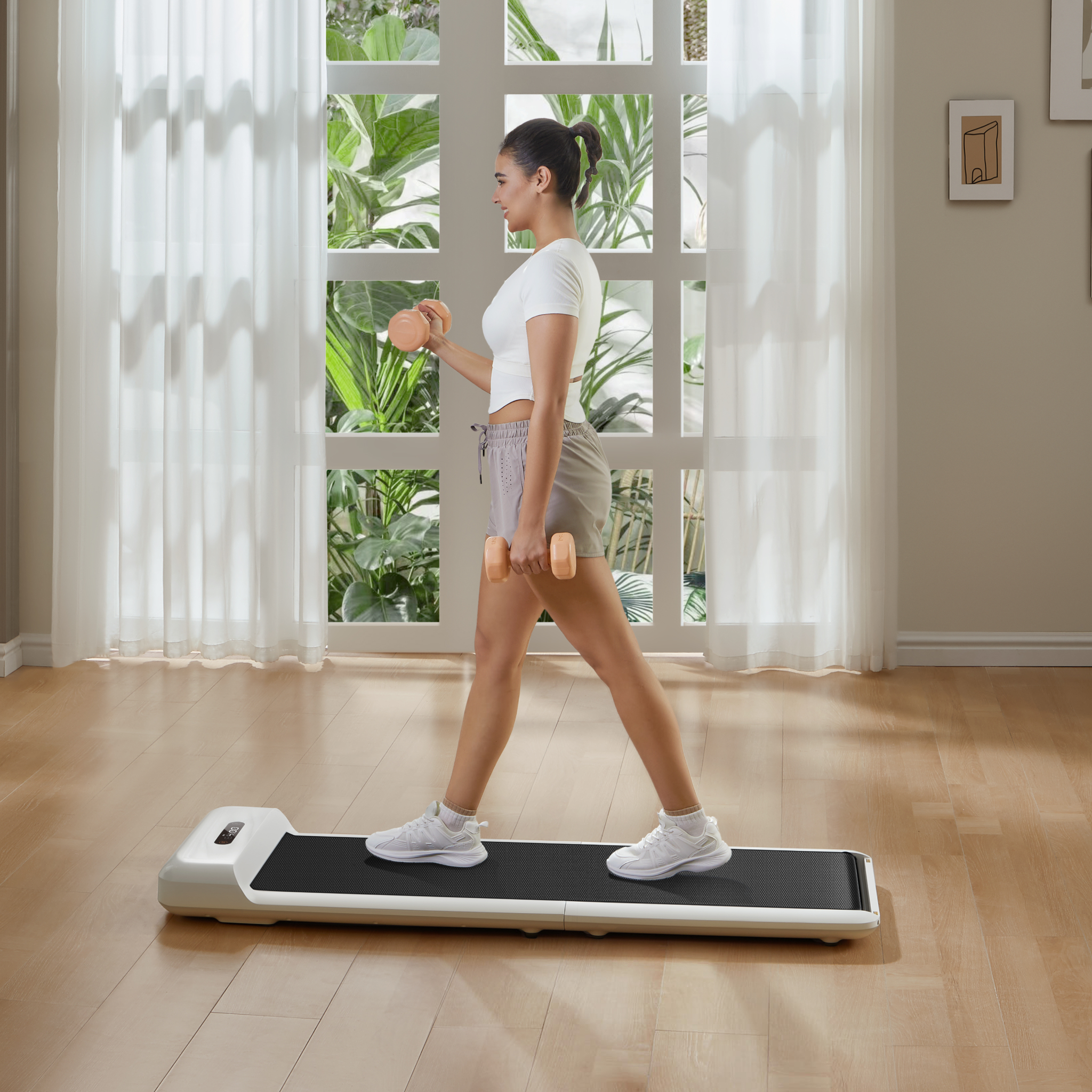 Woman walking on WalkingPad C2 Foldable Walking Treadmill in living room.