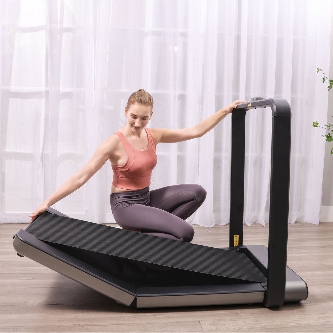 WalkingPad X21 Foldable Running Treadmill in living room being folded up. 