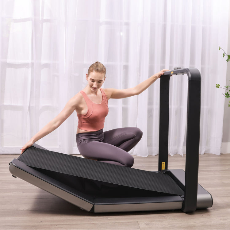 WalkingPad X21 Foldable Running Treadmill in living room being folded up. 