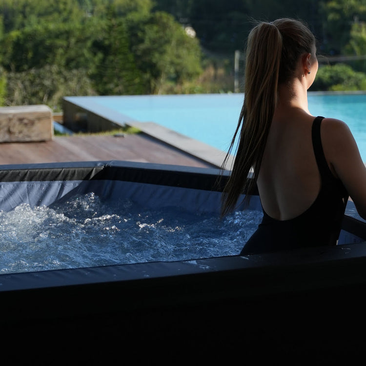Woman in bubbly water in spa.