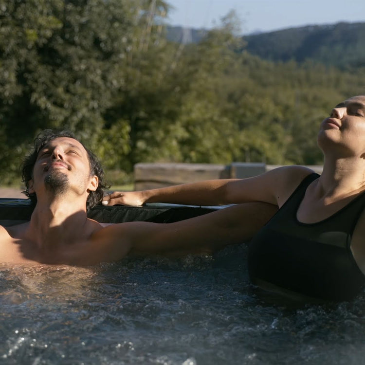Couple relaxing in spa with bubbly water.