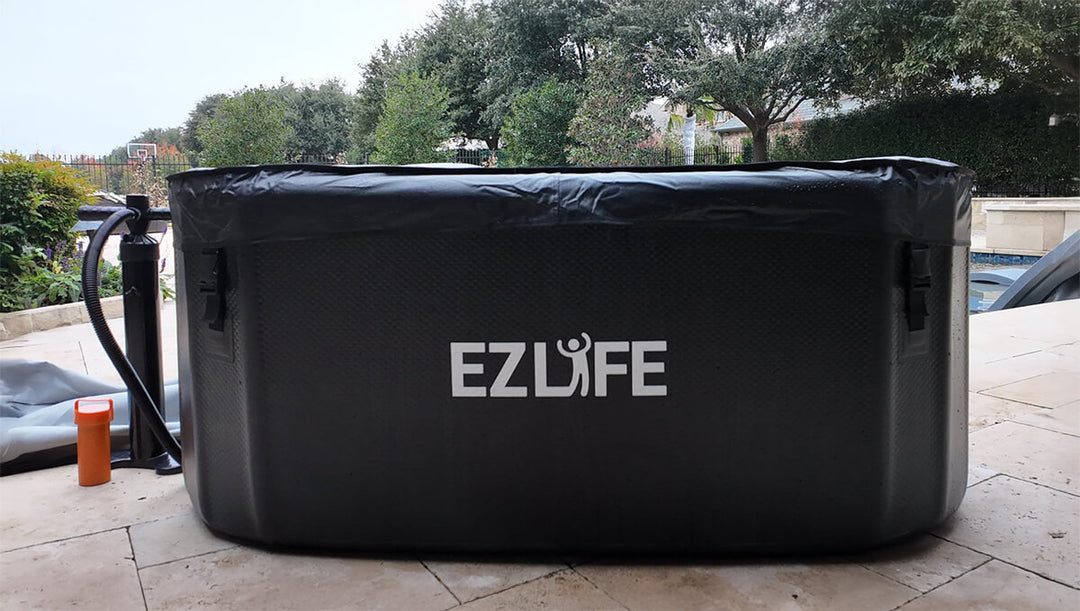 Black inflatable hot tub with 'EZLife' branding on a patio