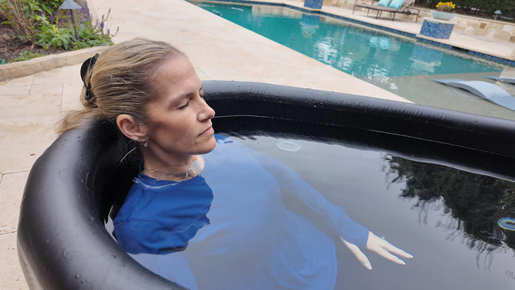 Close up of woman recovering in inflatable cold plunge.