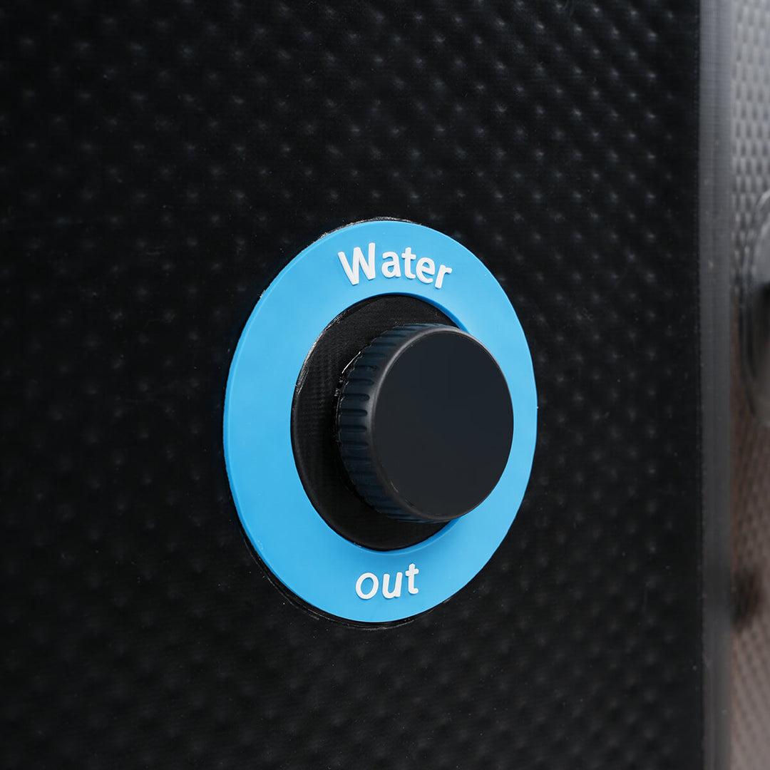 Plug cover on outside of inflatable cold plunge with the words "water out" in blue circle.
