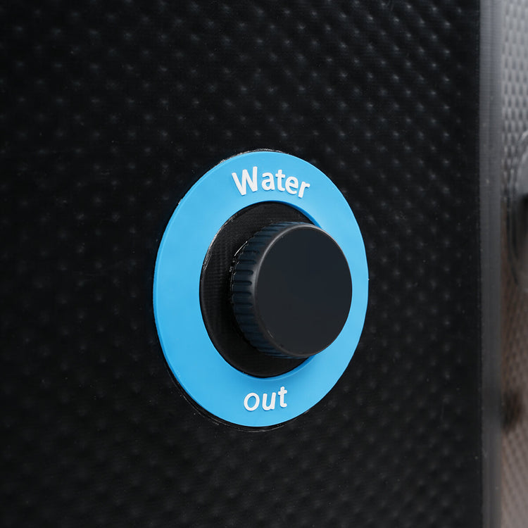 Plug cover on outside of inflatable cold plunge with the words "water out" in blue circle.