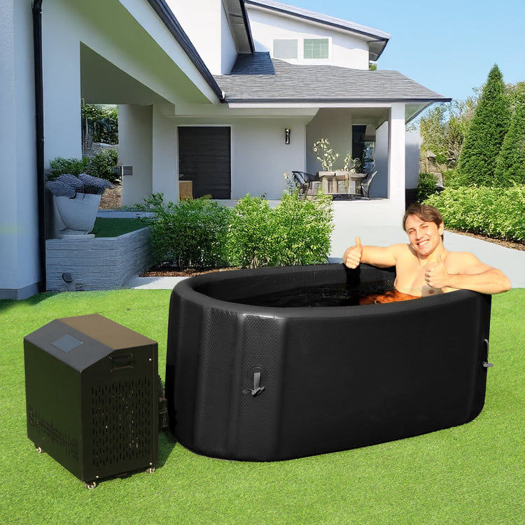 A man relaxing in the EZLIFE Oval Inflatable Cold Plunge giving two thumbs up.