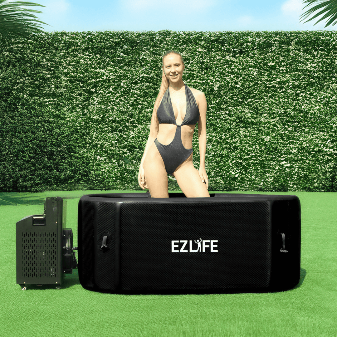 A woman standing in the EZLIFE Oval Inflatable Cold Plunge
