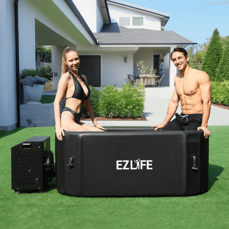 A couple sitting on the EZLIFE Oval Inflatable Cold Plunge
