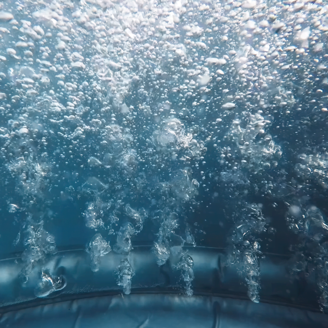 Underwater view of water jets bubbling.