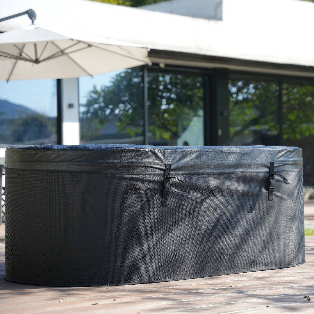 A near side view of the hot tub with the included cover clipped securely onto the top.