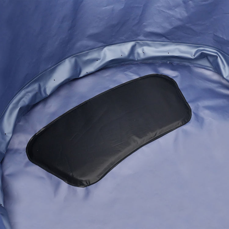 An interior view of a black cushion on the bottom of the blue interior colored spa.