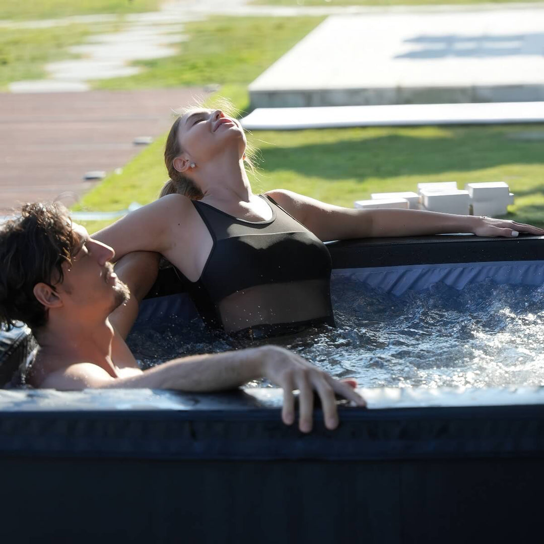 Couple relaxing in hot tub outside.