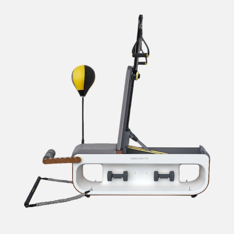 A gray and white exercise bench with a yellow and black punching bag attached to it, designed for strength training exercises.