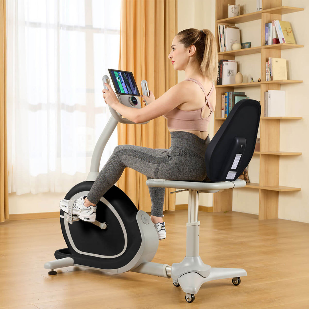 Angled photo from behind the R1 bike with woman working out with tablet and console in view.
