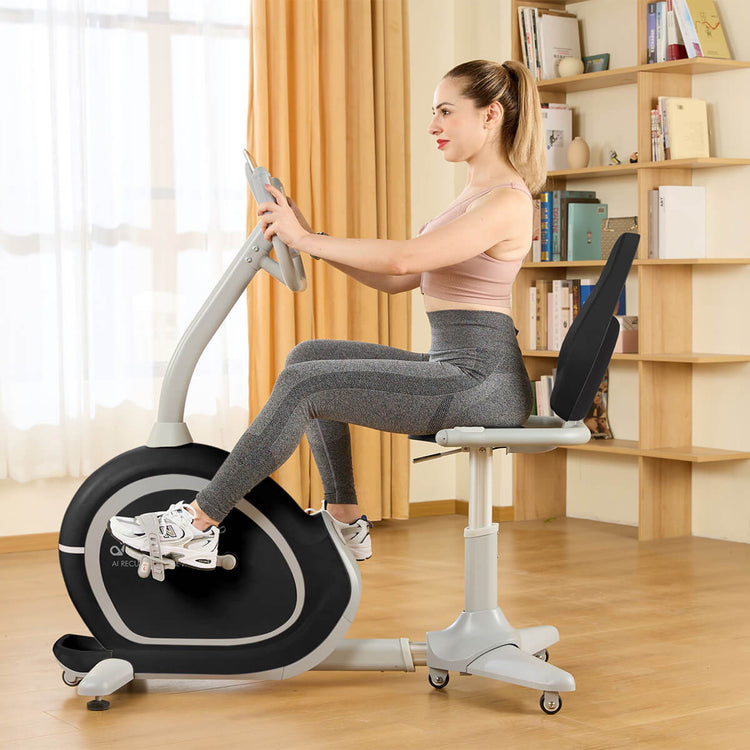 Woman working out on recumbent bike with the camera angle at a profile/side angle.
