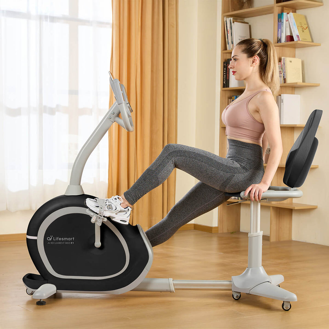 Woman in workout clothes exercising on R1 Smart Recumbent in her home. 