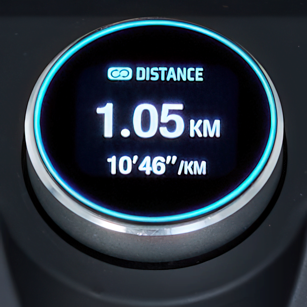 Close up of the dial that features the text "Distance," "1.05km," and "10'46"/km"