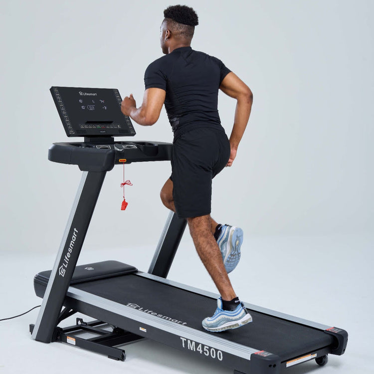 A man is running on the treadmill at an incline.