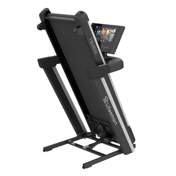 Treadmill folded in storage mode on white background.