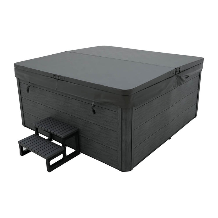 Product studio shot of spa with dark exterior with a cover on top.